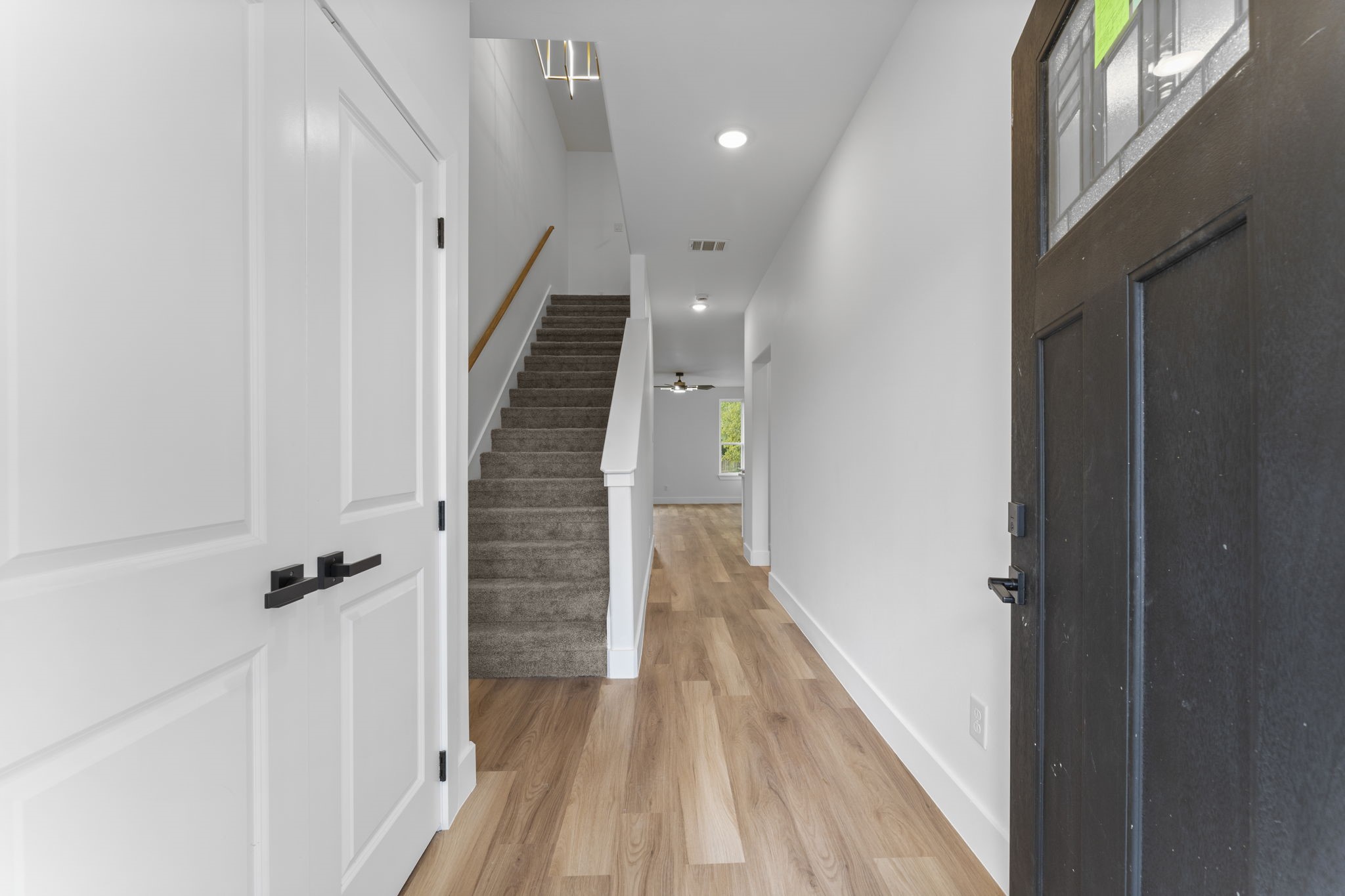 8205 Carver Road Houston, TX 77088 - Photo 6 of 37 a view of a hallway with wooden floor and staircase