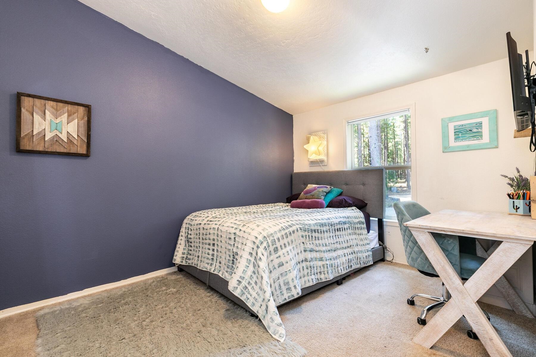 1015 Mountain Quail Road Calpine, CA 96124 - Photo 15 of 24 a bedroom with a bed and a table in it