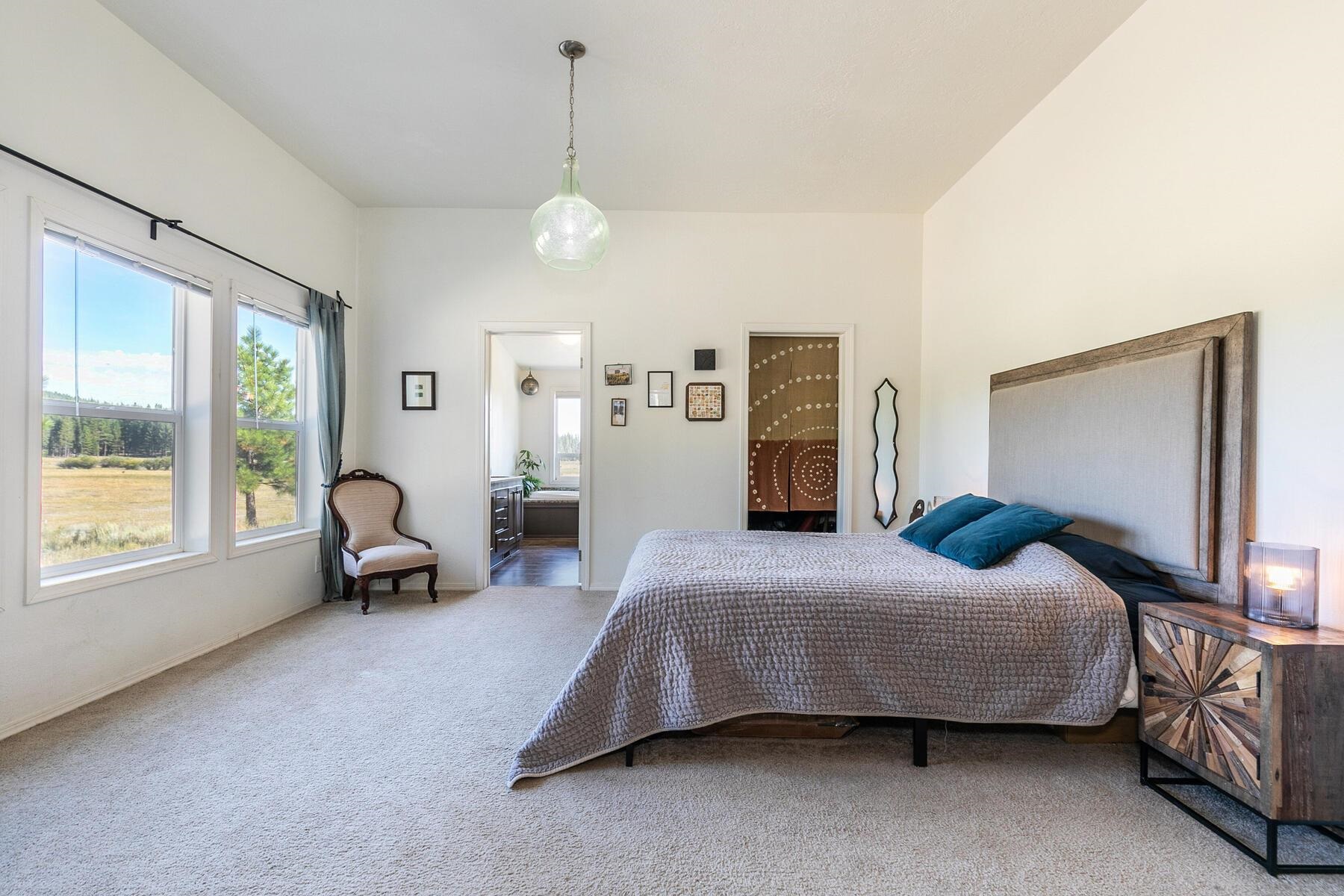 1015 Mountain Quail Road Calpine, CA 96124 - Photo 16 of 24 a bedroom with a bed couch and window