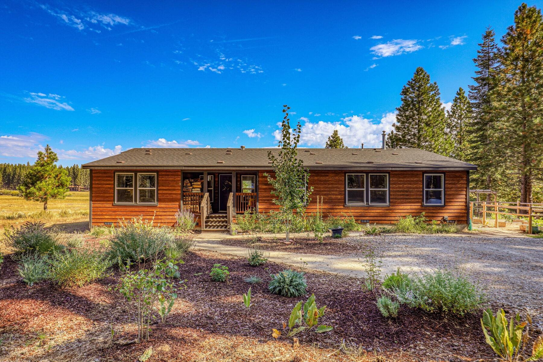 1015 Mountain Quail Road Calpine, CA 96124 - Photo 2 of 24 a front view of a house with garden