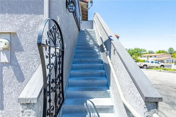 a view of a chairs and table in the balcony