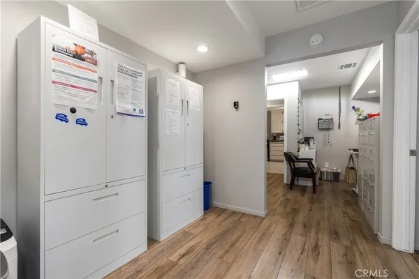 a view of a hallway with wooden floor
