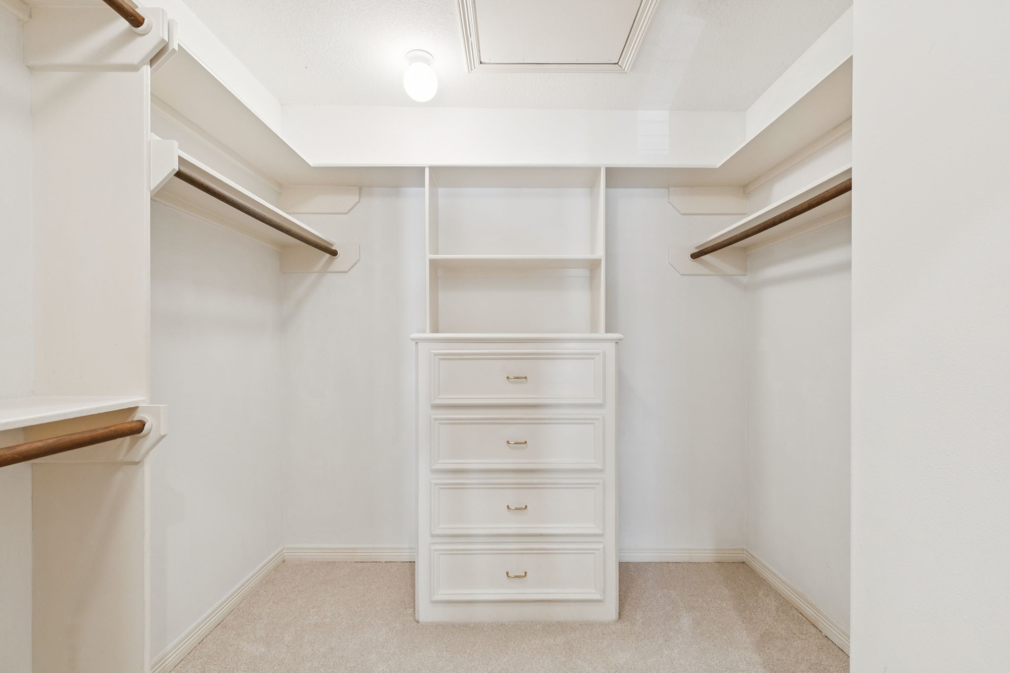 4916 Travis Street Houston, TX 77004 - Photo 15 of 26 Large walk-in closet with ample shelving and dedicated hanging areas, offering excellent storage solutions.