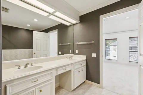 a bathroom with a sink double vanity and a mirror