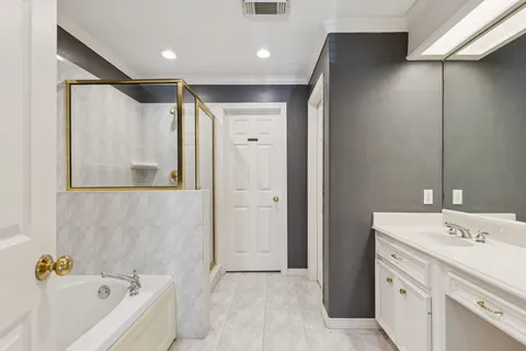 a bathroom with a tub sink and mirror