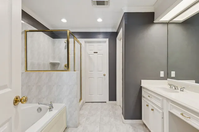 a bathroom with a tub sink and mirror