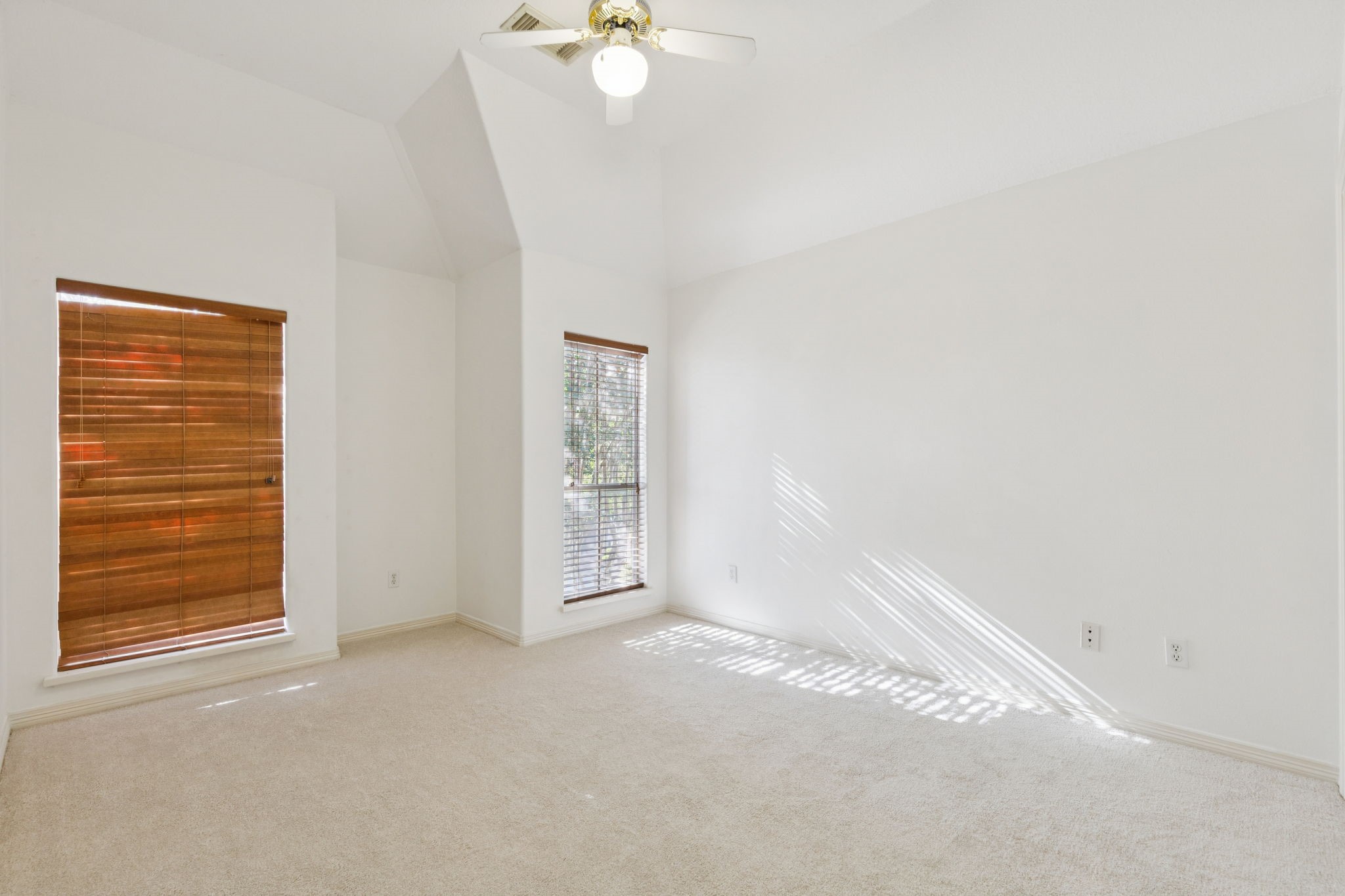 4916 Travis Street Houston, TX 77004 - Photo 23 of 26 Secondary bedroom features high ceilings and abundant natural light, creating a spacious and airy feel.