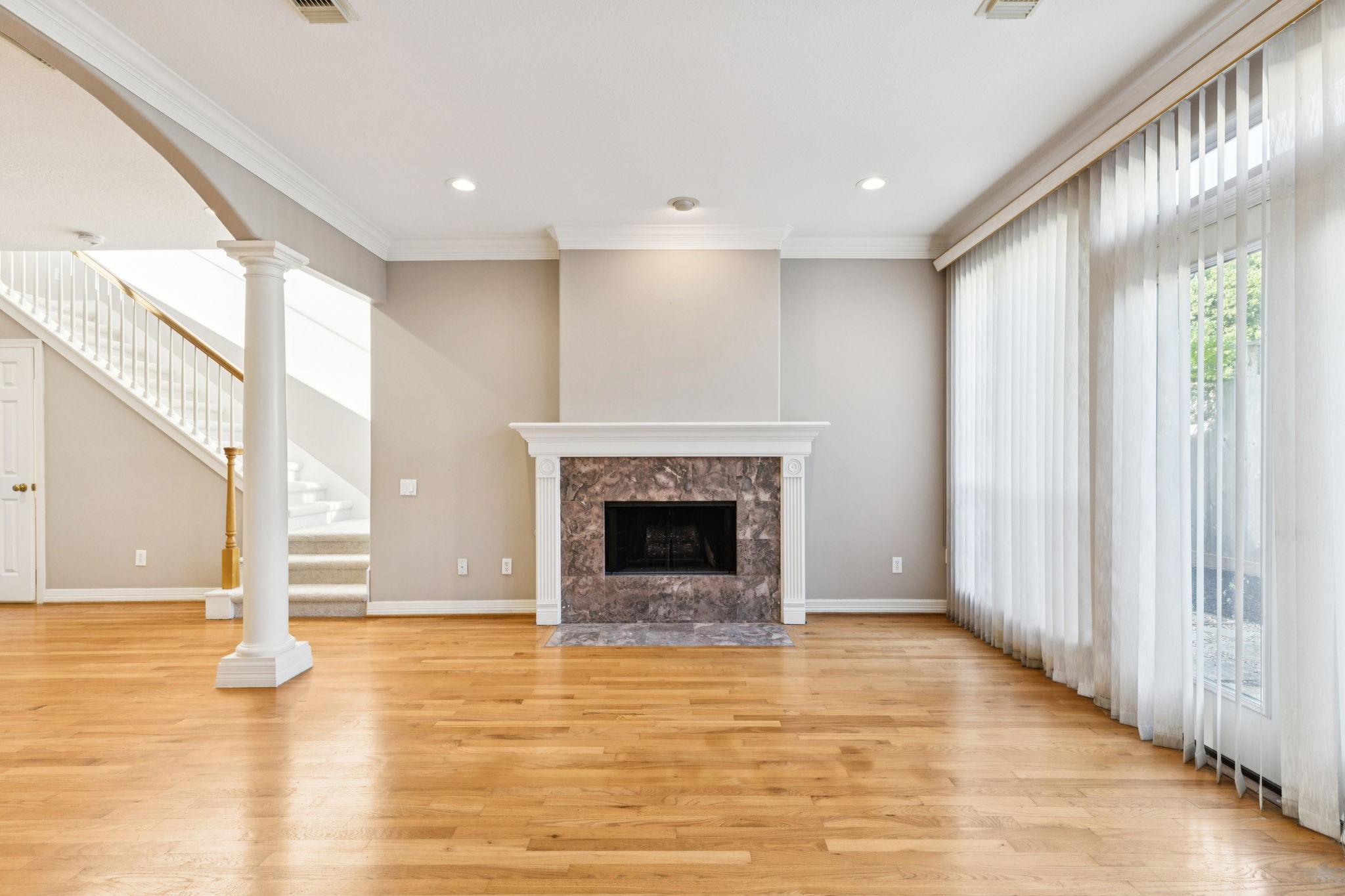 4916 Travis Street Houston, TX 77004 - Photo 6 of 26 Secondary view showcasing the living area, with a particular focus on the inviting gas log fireplace.