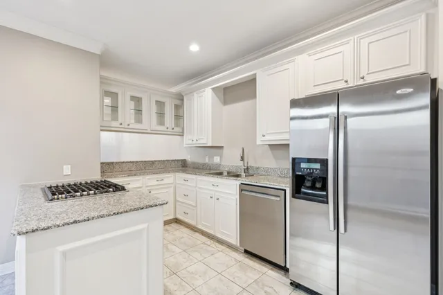 a kitchen with granite countertop cabinets and stainless steel appliances
