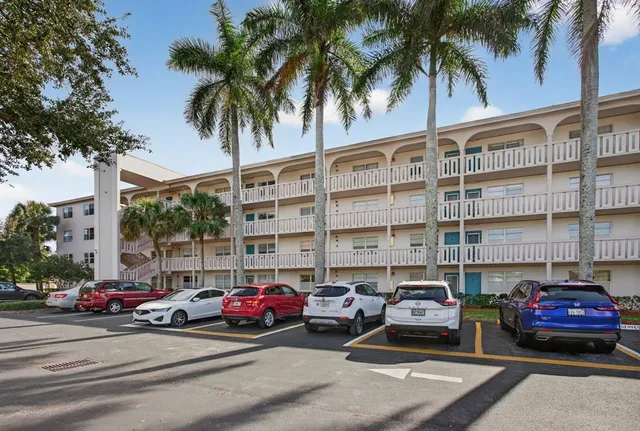 a view of a house with swimming pool and sitting area