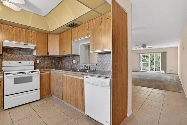 a kitchen with a stove cabinets and a sink