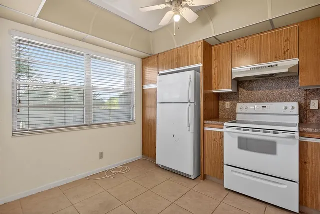 a kitchen with a stove cabinets and a refrigerator