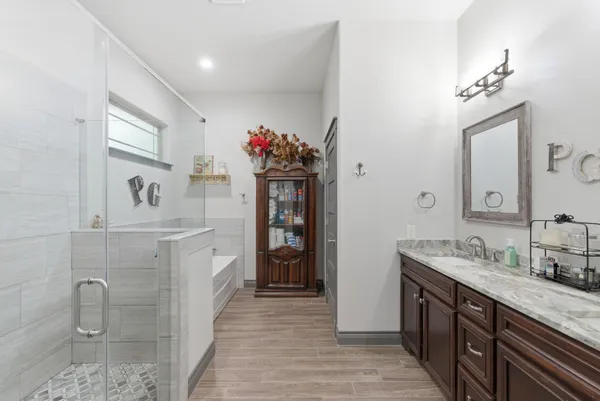 a spacious bathroom with a sink double vanity granite and a mirror