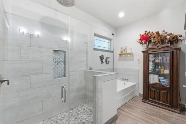 a bathroom with a sink mirror and shower