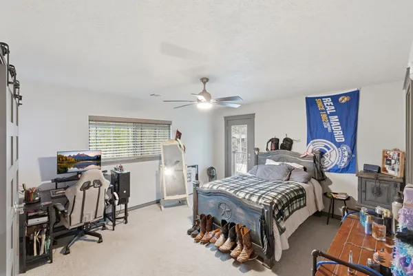 a bedroom with furniture and a gym equipment
