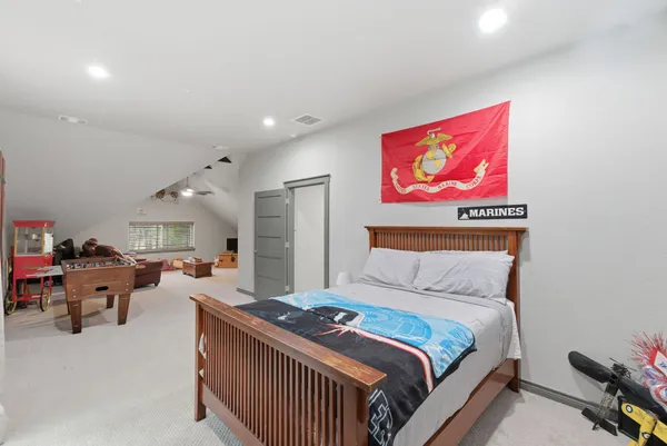 a bedroom with furniture and a chandelier