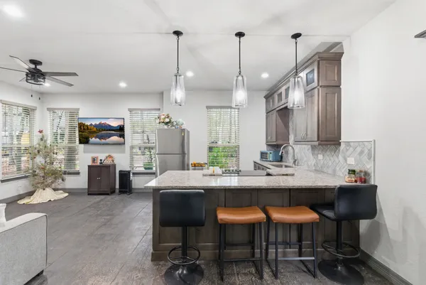 a kitchen with stainless steel appliances kitchen island granite countertop a sink and cabinets