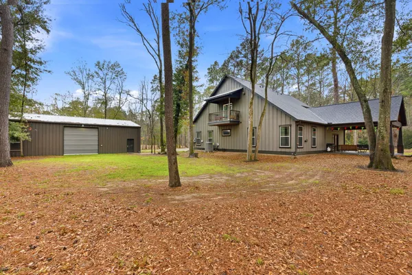 a view of a house with a yard and tree