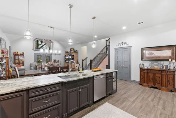 a view of center island wooden floor and windows