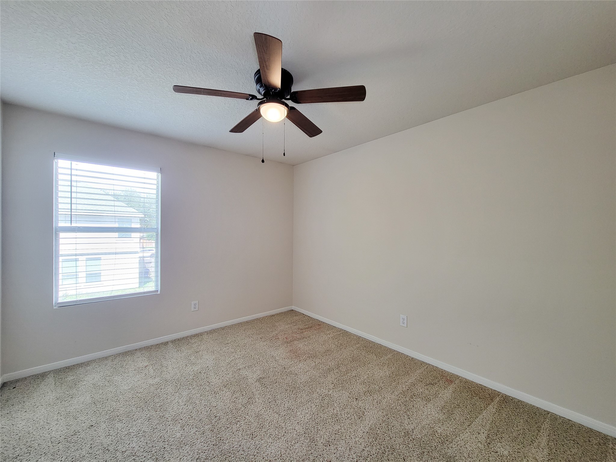 19330 Harvest Stream Way Houston, TX 77084 - Photo 32 of 50 an empty room with a window and a fan