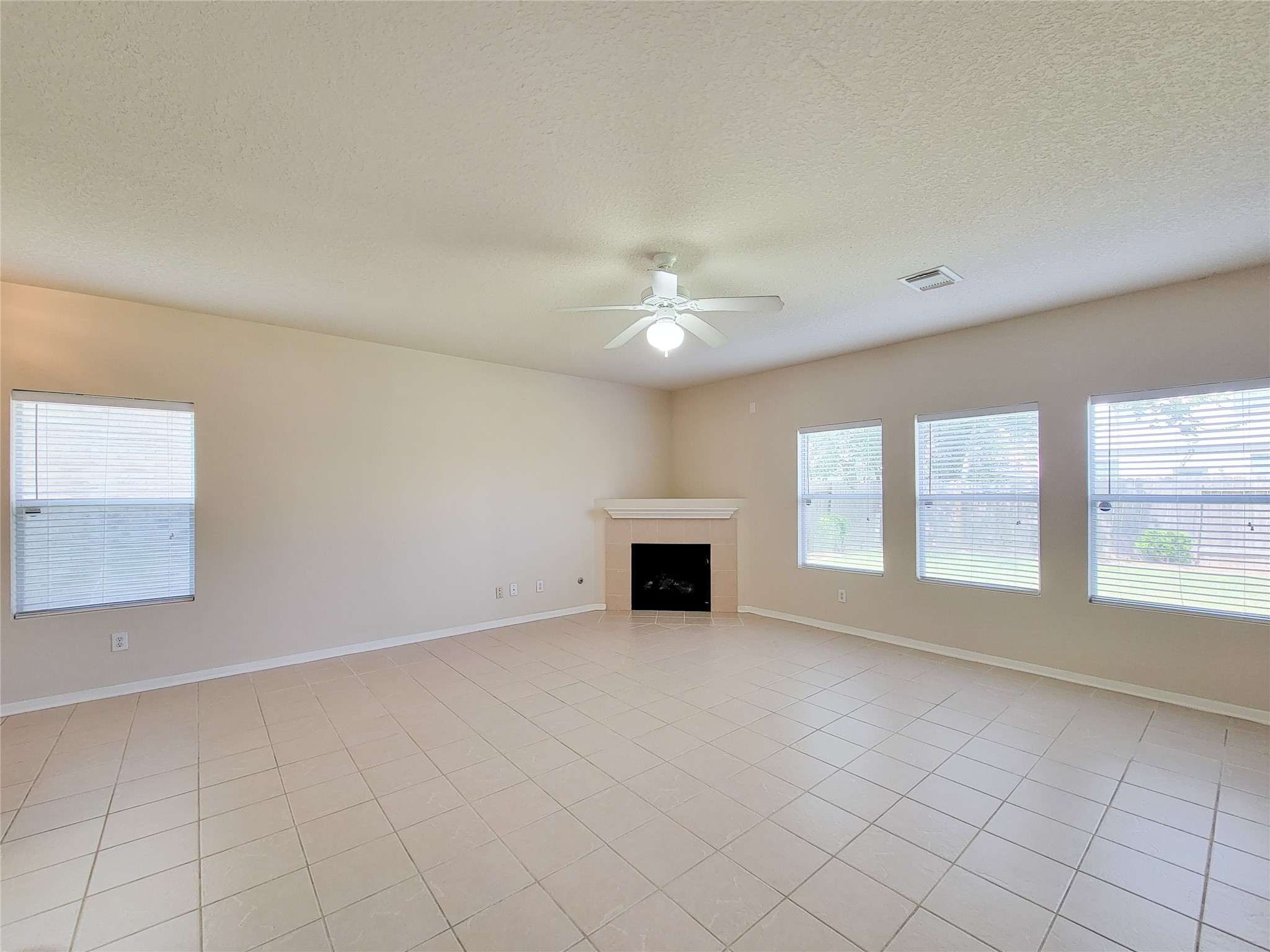19330 Harvest Stream Way Houston, TX 77084 - Photo 8 of 50 an empty room with windows and fireplace