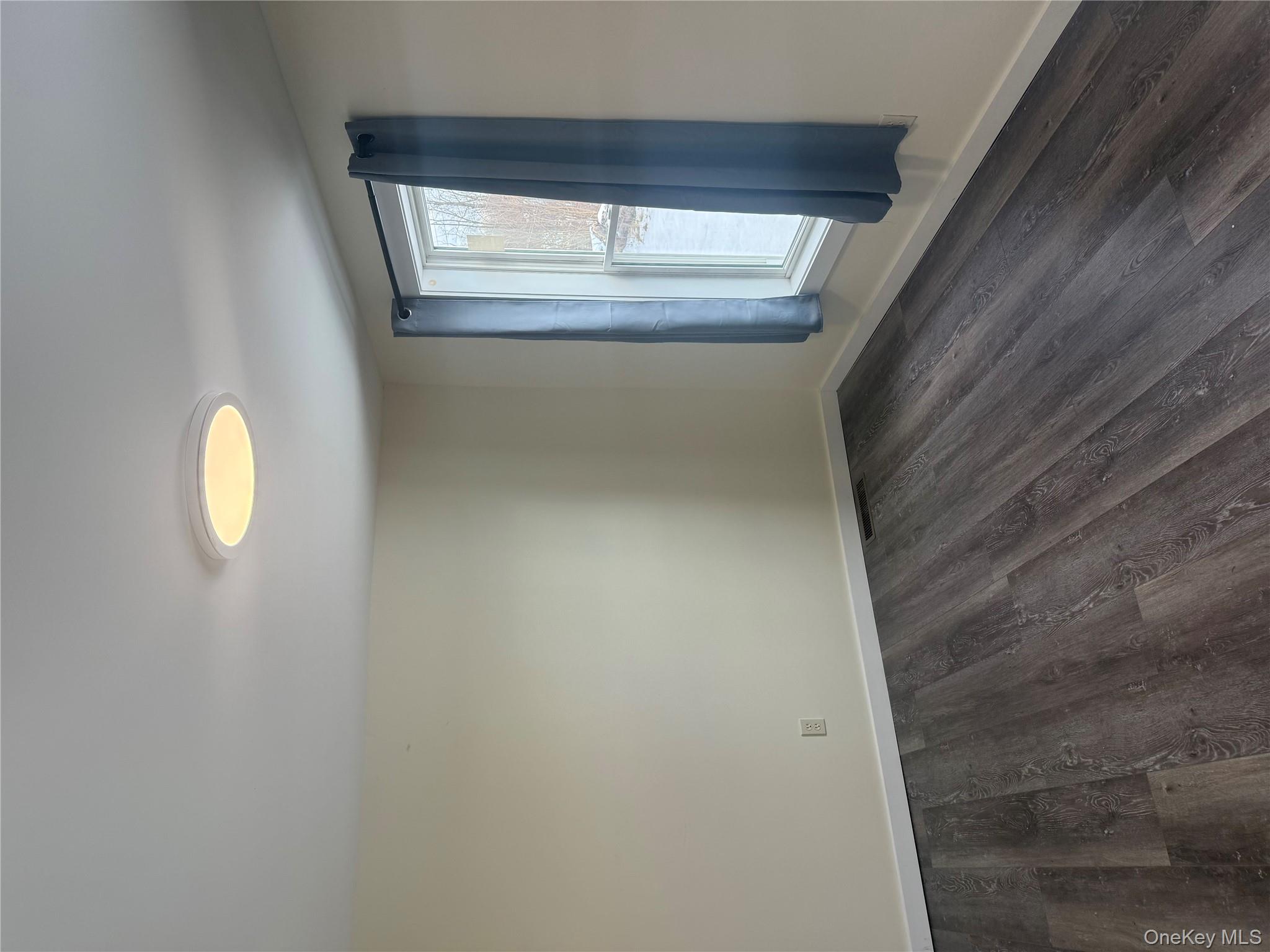 92 Wigsten Road, Unit 1 Pleasant Valley, NY 12569 - Photo 4 of 8 an empty room with wooden floor and windows