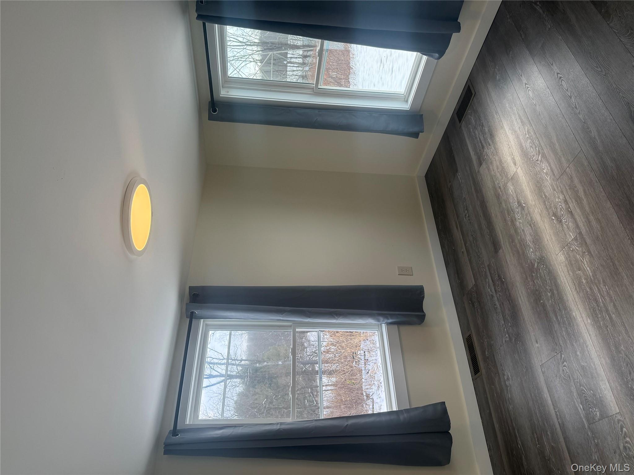 92 Wigsten Road, Unit 1 Pleasant Valley, NY 12569 - Photo 5 of 8 an empty room with wooden floor and windows