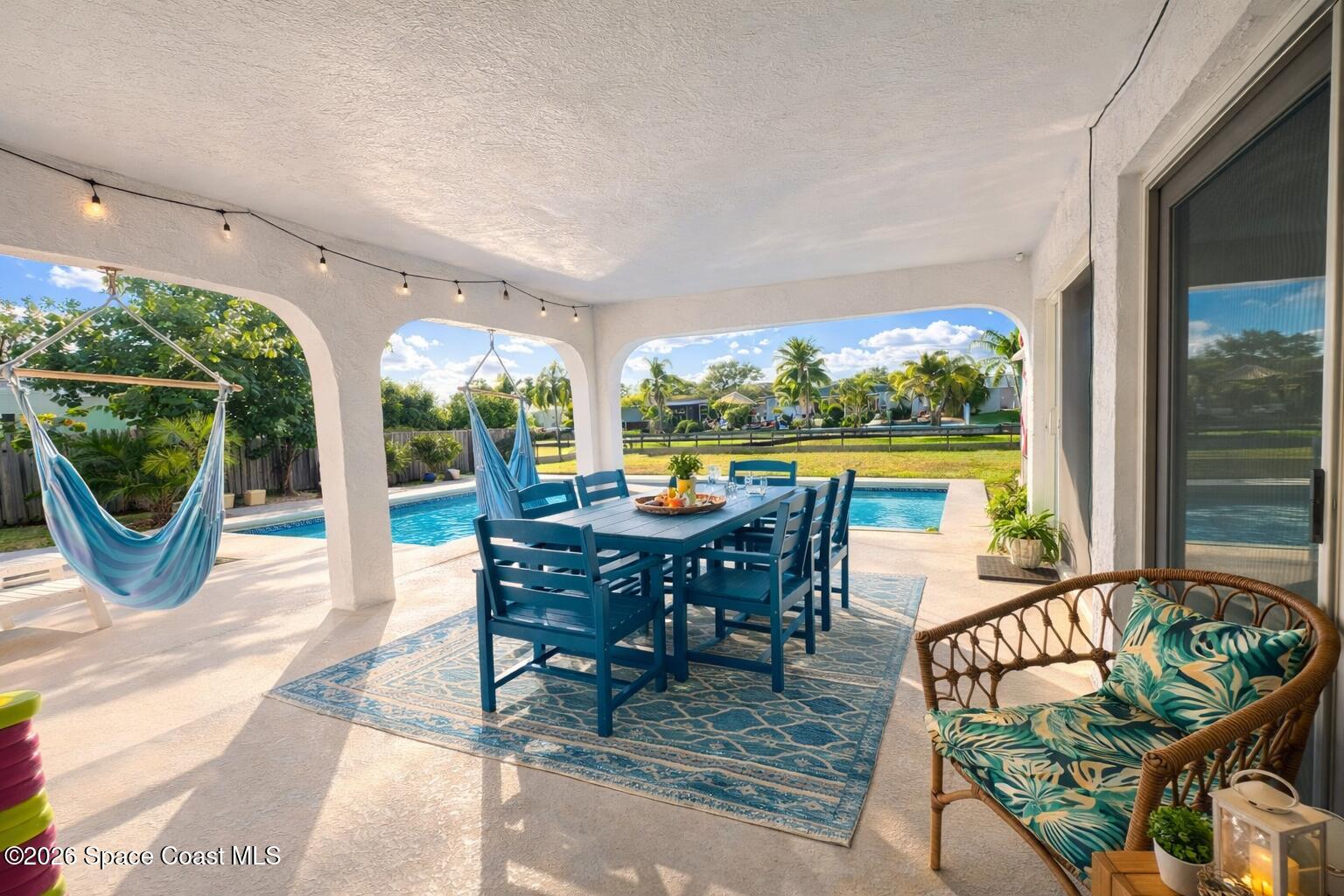 120 Boca Ciega Road Cocoa Beach, FL 32931 - Photo 14 of 23 a view of a patio with a dining table and chairs