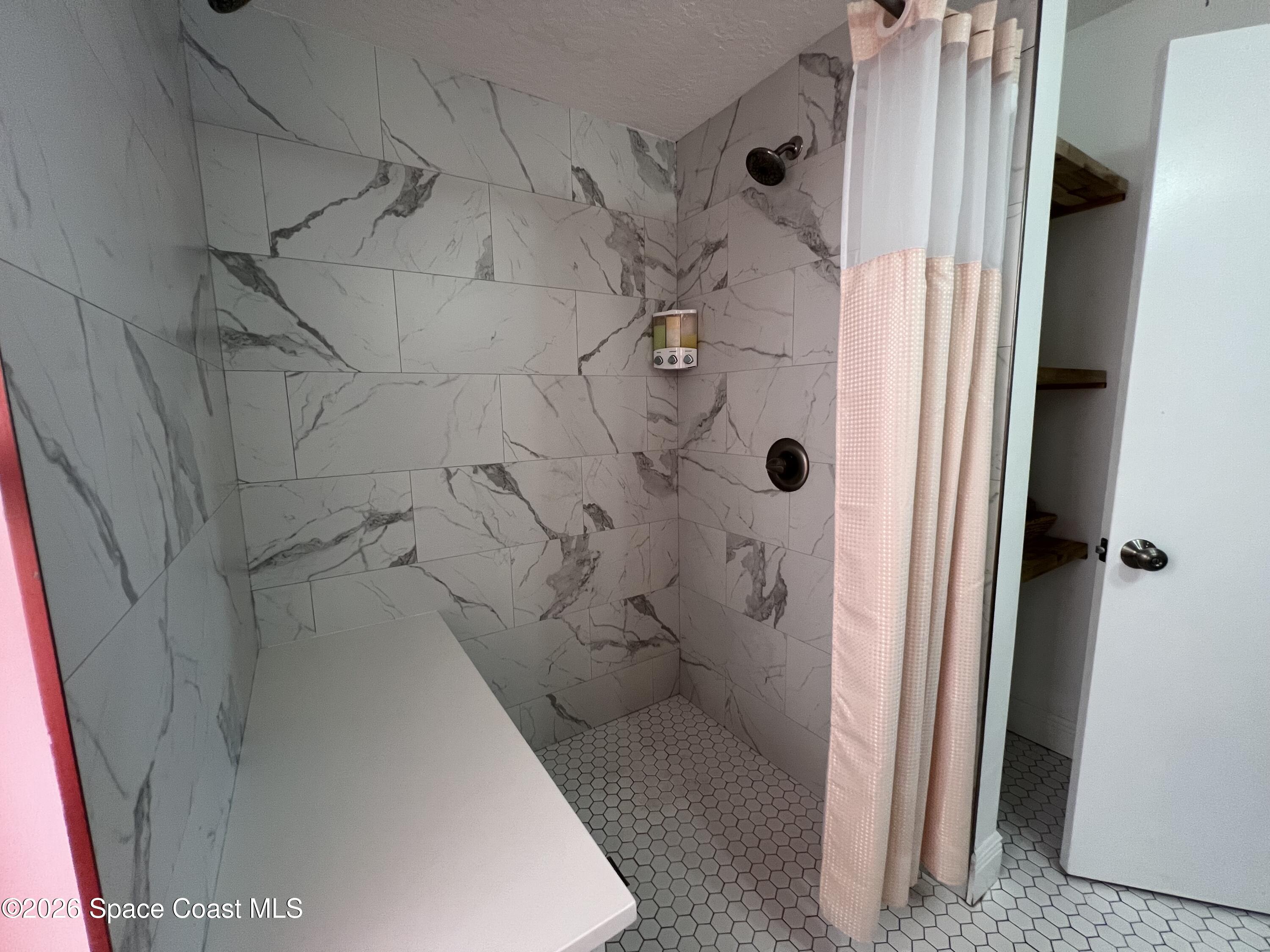 120 Boca Ciega Road Cocoa Beach, FL 32931 - Photo 20 of 23 a bathroom with a shower and a toilet