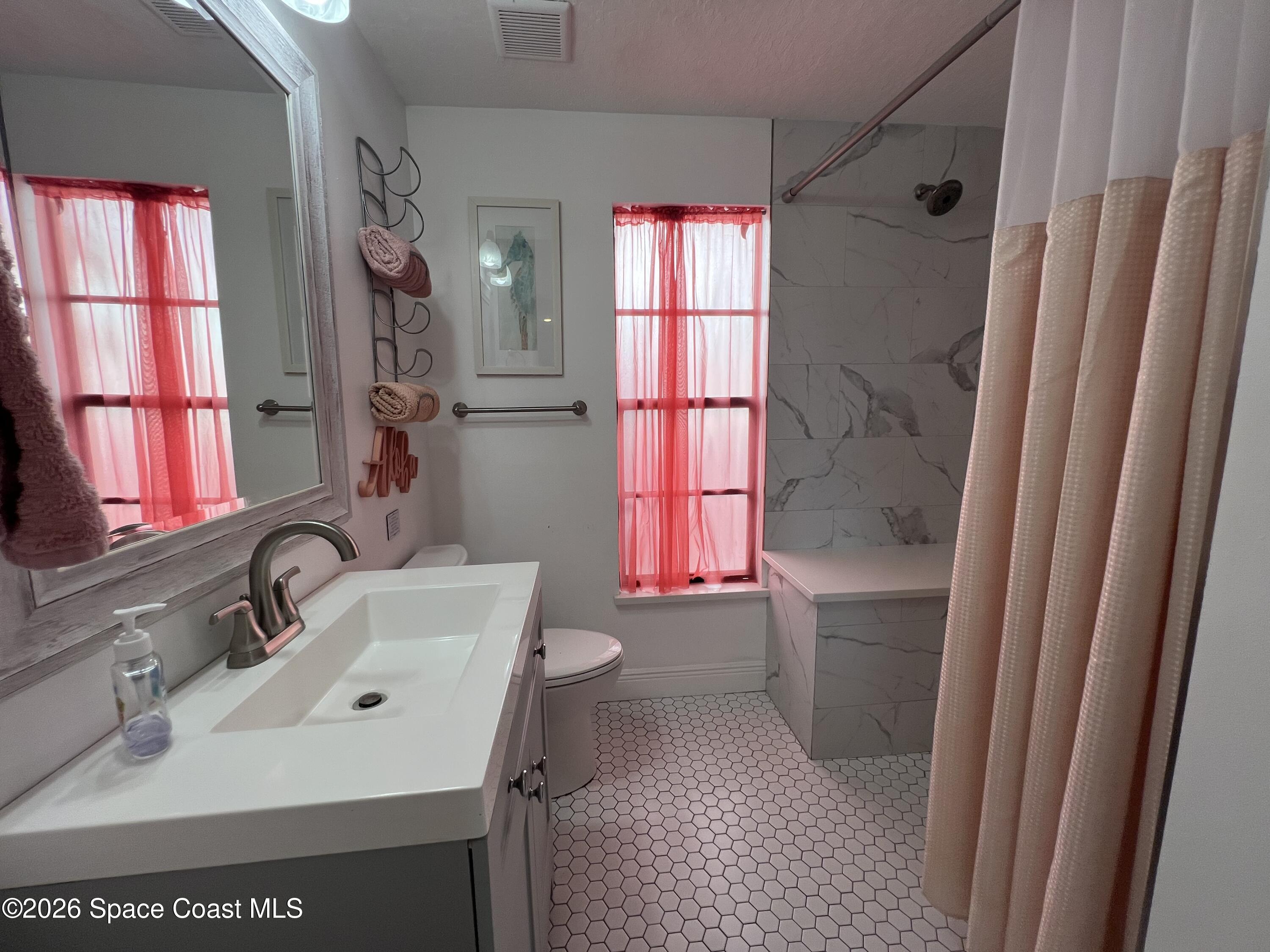 120 Boca Ciega Road Cocoa Beach, FL 32931 - Photo 21 of 23 a bathroom with a sink a bathtub and a window