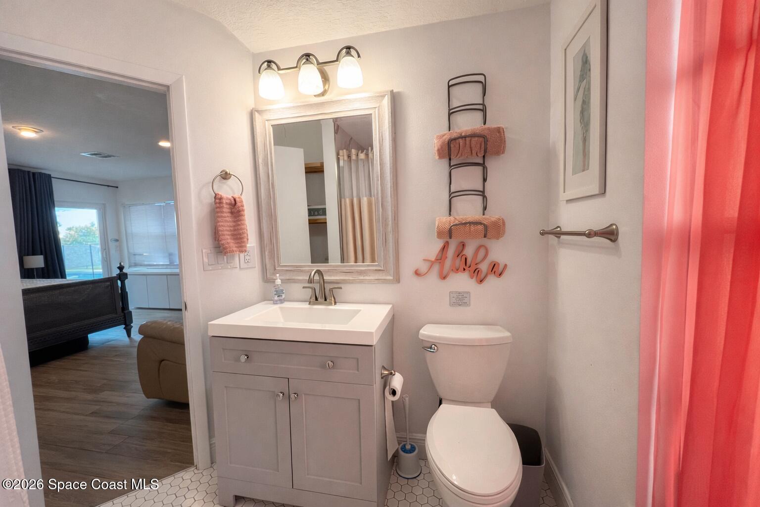 120 Boca Ciega Road Cocoa Beach, FL 32931 - Photo 23 of 23 a bathroom with a toilet sink and mirror