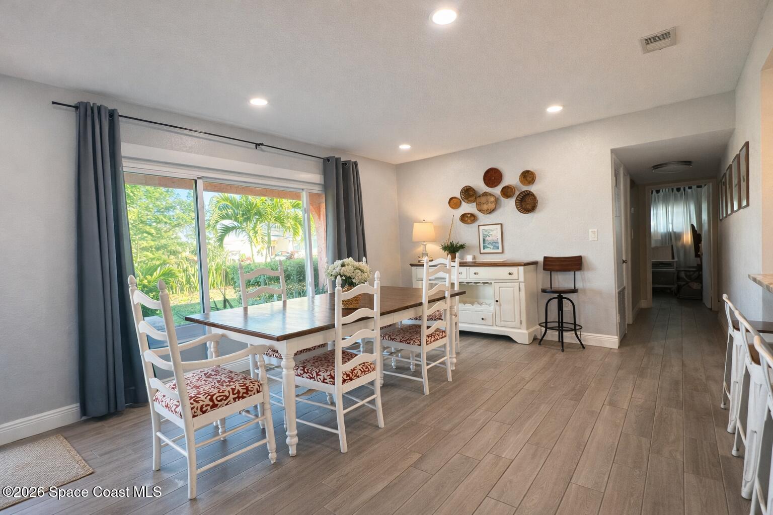 120 Boca Ciega Road Cocoa Beach, FL 32931 - Photo 3 of 23 a living room with furniture and wooden floor