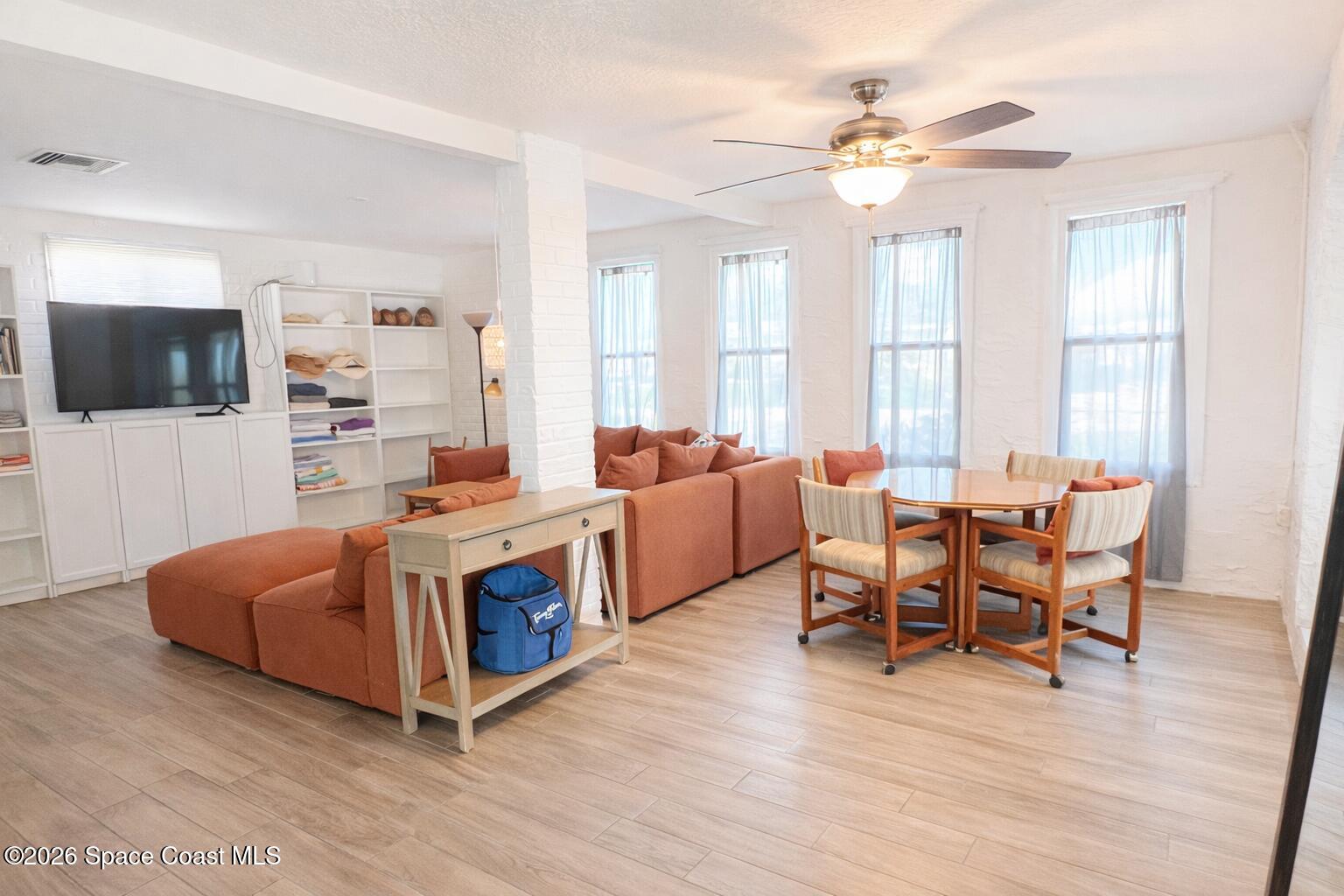 120 Boca Ciega Road Cocoa Beach, FL 32931 - Photo 7 of 23 a living room with furniture and a flat screen tv