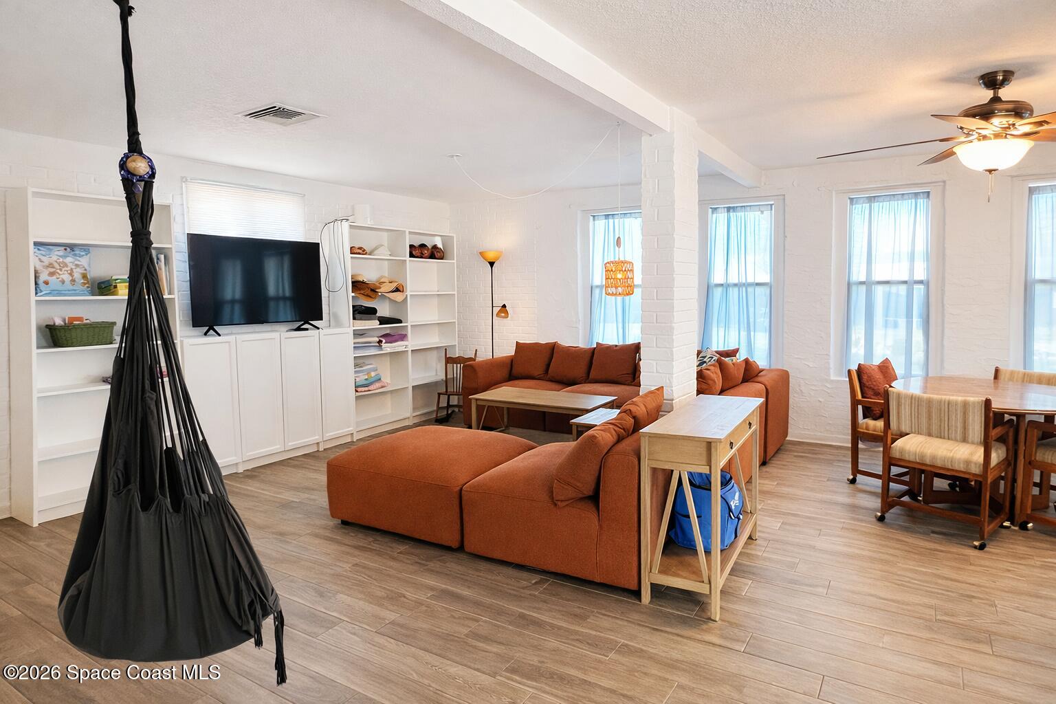 120 Boca Ciega Road Cocoa Beach, FL 32931 - Photo 8 of 23 a living room with furniture and a flat screen tv