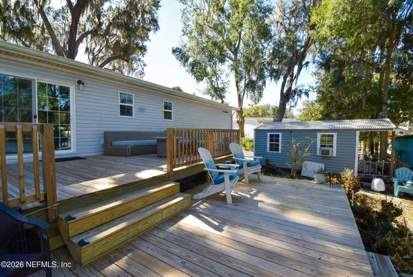 a view of a backyard with sitting area