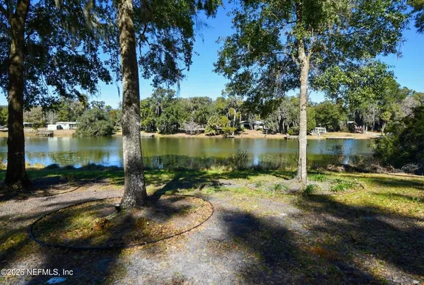 a view of a lake with a yard