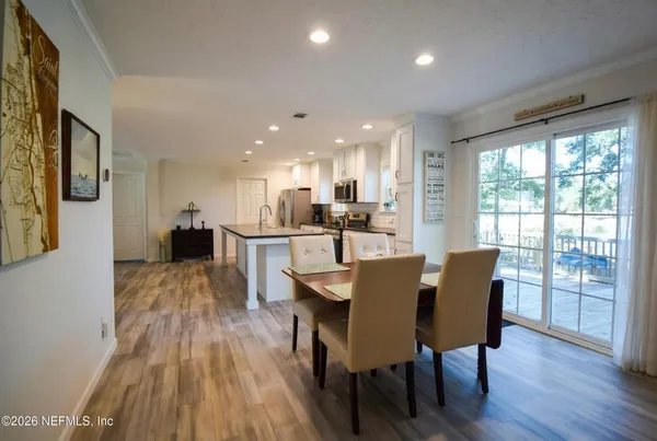 a view of a dining room with furniture and wooden floor
