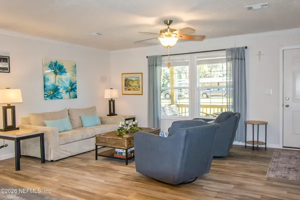 a living room with furniture and a large window