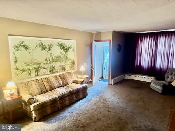 a living room with furniture and large window
