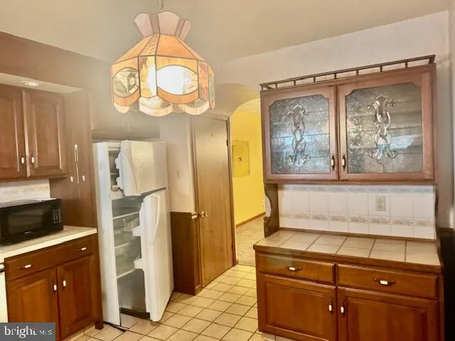 a kitchen with stainless steel appliances granite countertop a refrigerator and a stove