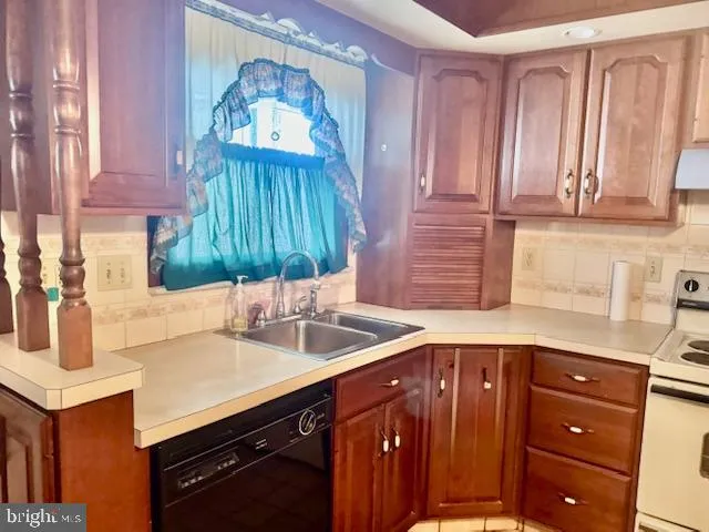 a kitchen with a sink cabinets and a window