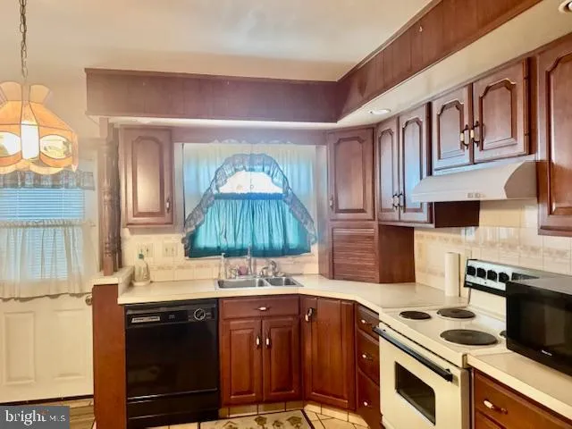 a kitchen with stainless steel appliances a sink stove and cabinets