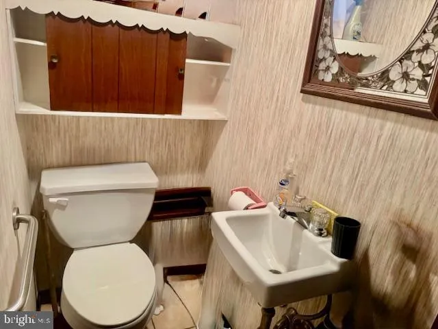 a bathroom with a toilet and a sink