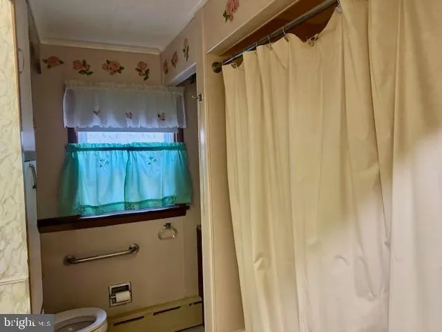 a bathroom with a shower curtain and a mirror