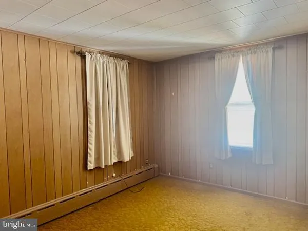 a view of a closet with wooden floor