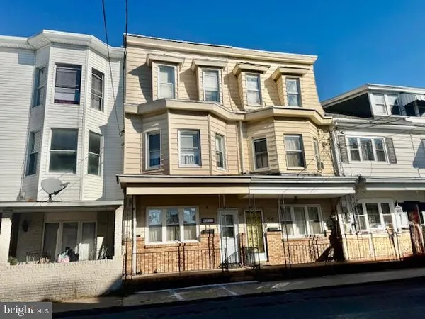 a front view of residential building with swimming pool