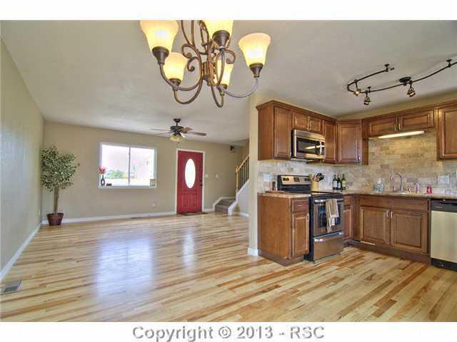 10865 Falling Star Road Fountain, CO 80817 - Photo 4 of 23 Living room has access to dining room, kitchen and main level bedrooms.