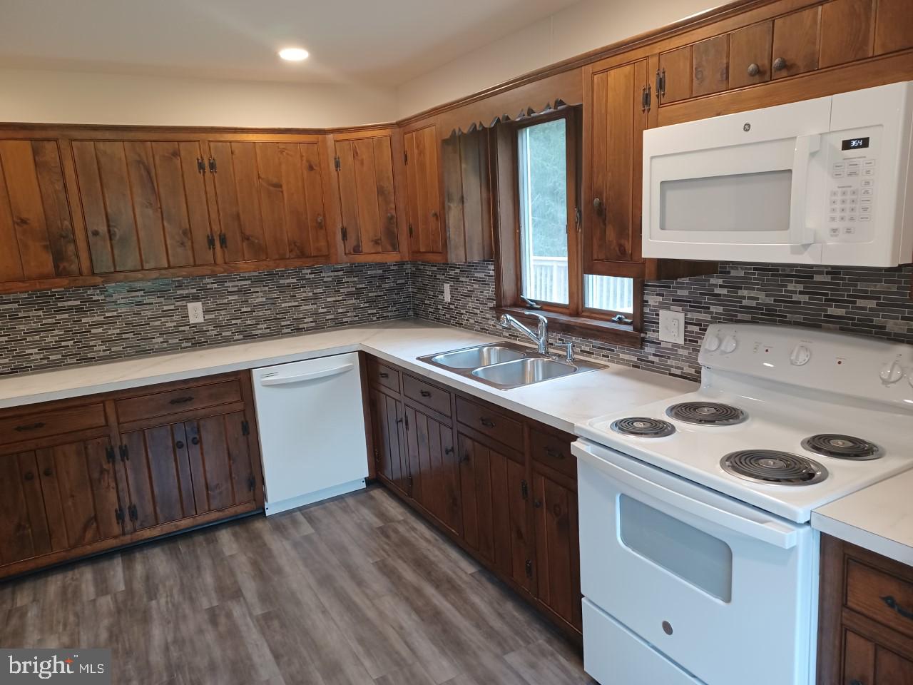 1525 Yardley Newtown Road, Unit 1 Morrisville, PA 19067 - Photo 4 of 14 a kitchen with a sink stove and cabinets