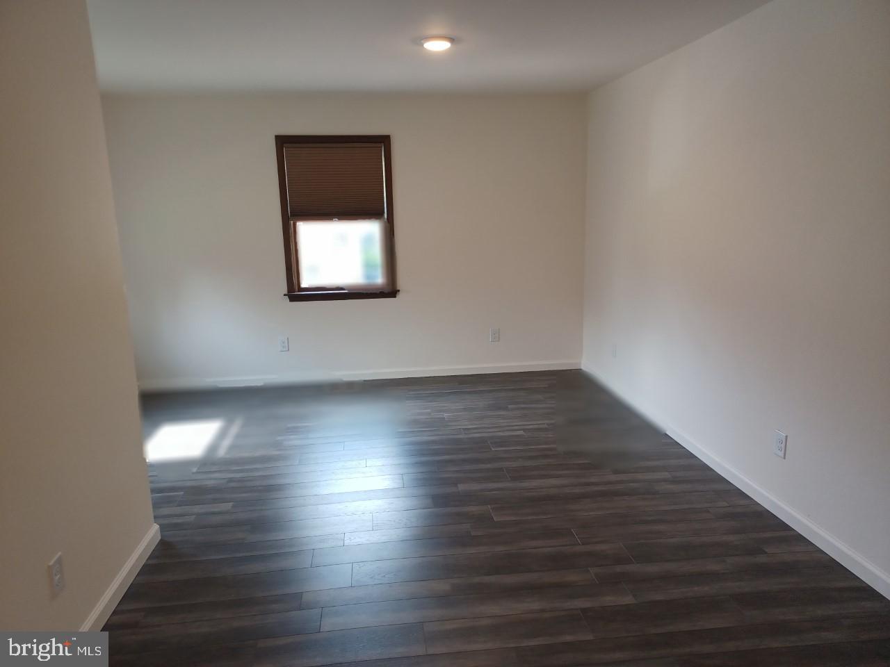 1525 Yardley Newtown Road, Unit 1 Morrisville, PA 19067 - Photo 5 of 14 an empty room with wooden floor and windows