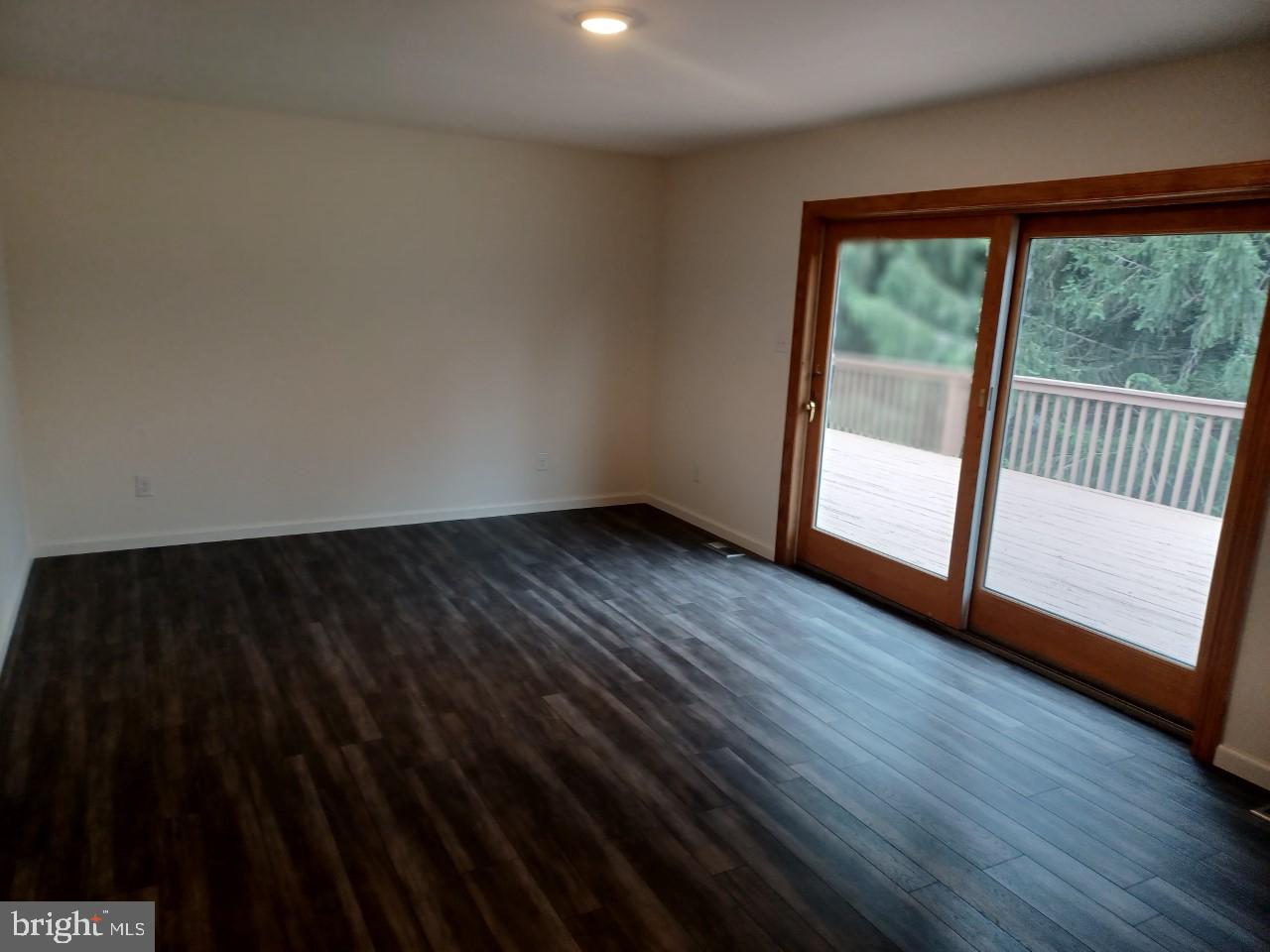 1525 Yardley Newtown Road, Unit 1 Morrisville, PA 19067 - Photo 6 of 14 a view of empty room with wooden floor and fan